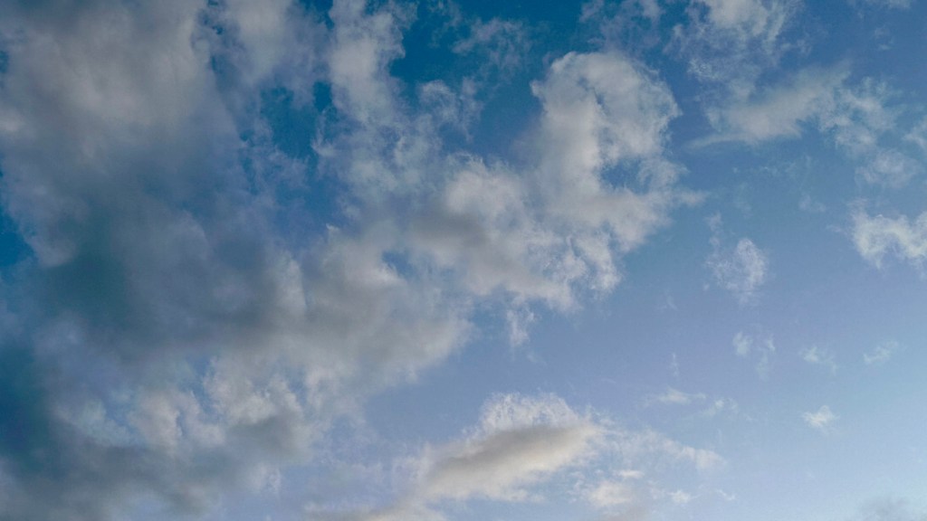 Looking up at the partly cloudy blue Michigan sky on April 17, 2026, the day of the new moon in Aries.